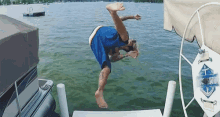 a man is jumping into a lake from a boat