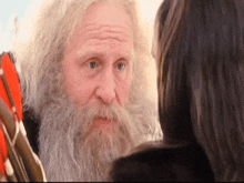 a man with a beard is looking at a woman with long hair