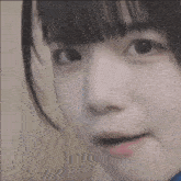 a close up of a girl 's face with a slight smile