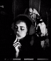 a black and white photo of a person with the name demiswag on the bottom right