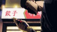 a man in a suit is holding a figurine in front of a sign that says ' 餃子 '