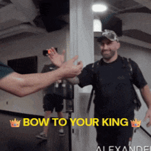 a man giving another man a high five with the words bow to your king