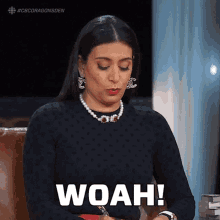 a woman wearing a pearl necklace and earrings says woah .