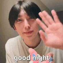a man says good night with his hand