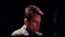 a group of people are standing in a row and their faces are lit up with neon colors