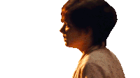 a woman with short brown hair is wearing a white robe
