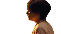 a woman with short brown hair is wearing a white robe