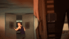 a man in a black tank top stands in a doorway