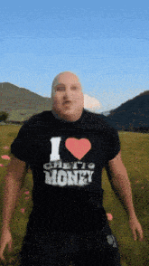 a bald man wearing a black shirt that says i love money
