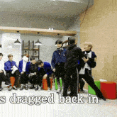 a group of people are standing in a room with the words ' sdragged back in ' written on the bottom