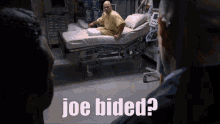 a man in a hospital bed with joe bided written on the bottom