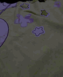 a bed with a blanket with flowers and stars on it