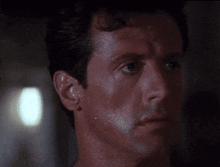a close up of a man 's face with sweat coming out of his face