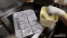 a person is preparing food in a kitchen with a container that says made in animatica