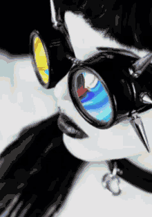 a woman wearing a choker and goggles with a rainbow lens