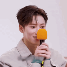 a close up of a person holding a microphone in front of their face