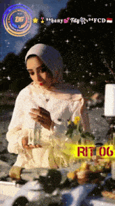 a woman in a hijab is holding a candle in front of a table with flowers and candles