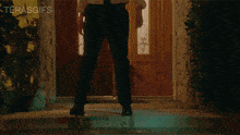 a man is kneeling down in front of a door with the words terasgifs on the bottom