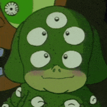 a close up of a green monster with three eyes