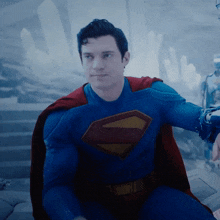 a man in a superman costume has a red cape