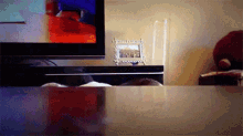 a picture frame sits on a table next to a tv