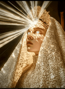a woman with a veil on her head has a crown on her head and glowing eyes