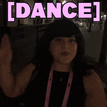 a woman wearing a black top and a pink lanyard that says shagarita