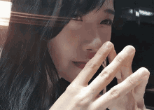 a close up of a woman 's face and hands