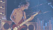 a blurred image of a person playing a guitar with the letter d below them