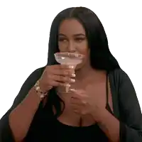 a woman with a tattoo on her arm is drinking from a margarita glass