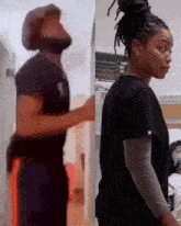 a man and a woman are standing next to each other in a hospital