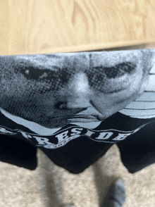 a black shirt has a picture of a man and the word side on it