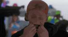 a man wearing a red hat and goggles holds his mouth open