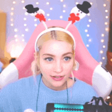 a woman wearing a headband with a snowman on it