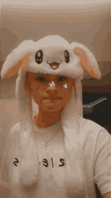 a person wearing a bunny hat and a shirt that says ' s.i.e.t. ' on it