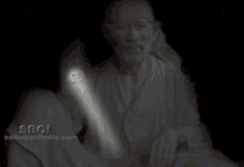 a statue of a man with a red bindi on his forehead and a light coming out of his hand