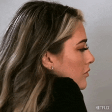 a close up of a woman 's face with a black shirt on .