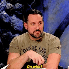 a man with a beard wearing a shirt that says diadelos