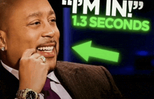 a man in a suit is smiling in front of a sign that says 1.3 seconds