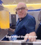 a man sitting on an airplane with the words she 's mad there are no pajamas written below him