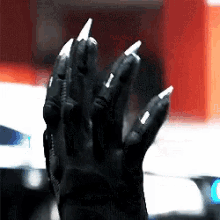a close up of a person 's hand with long nails