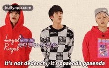 a group of young men standing next to each other wearing hoodies .