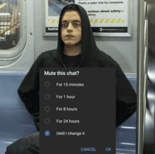a man in a hoodie is sitting on a subway with a mute this chat screen displayed