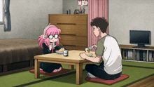 a man and a girl sit at a table with a sign that says mich on the wall behind them