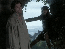 a man and a girl are standing next to each other in a cave