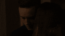 a man and woman are kissing in the dark