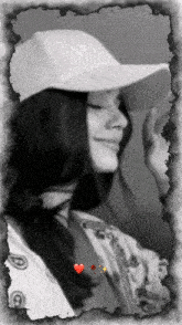a black and white photo of a woman wearing a white hat with the word nike on it
