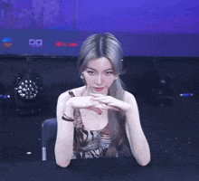 a woman sitting in front of a screen that says star