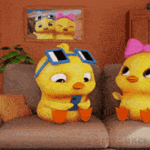 two cartoon ducklings are sitting on a couch and one is looking at a cell phone