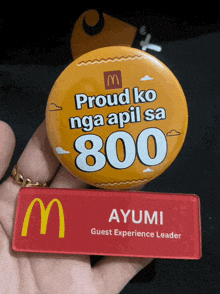 a person is holding a button that says proud ko nga apil sa 800